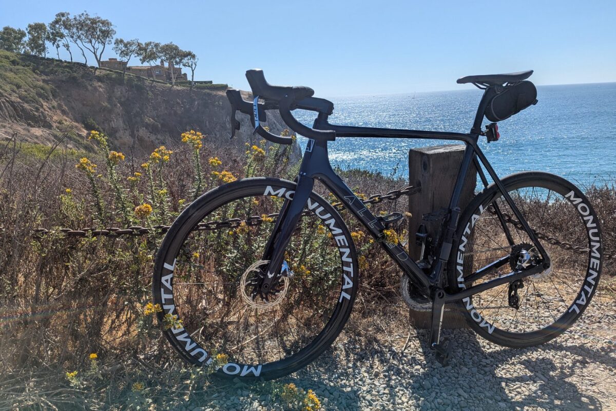 mcw_home_podium_coast Road bike with Monumental carbon wheels on a coastal bluff